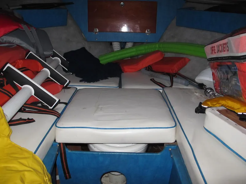 Slide: The Image of Interior of a 1990 Skiff Craft 26 boat with life jackets and seating. - 10