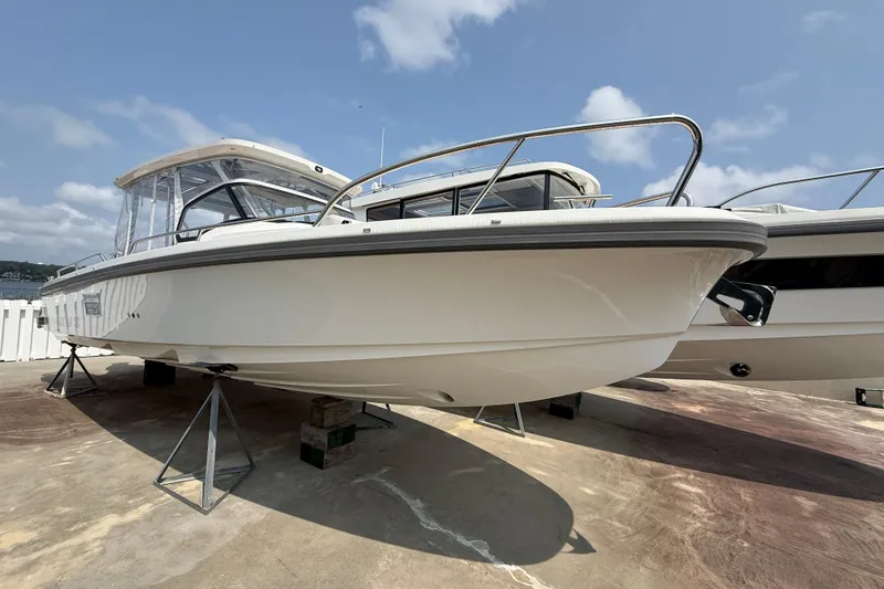 The Image of 2025 Nimbus Tender 9 boat on stands, displayed outdoors under a clear sky. - 0