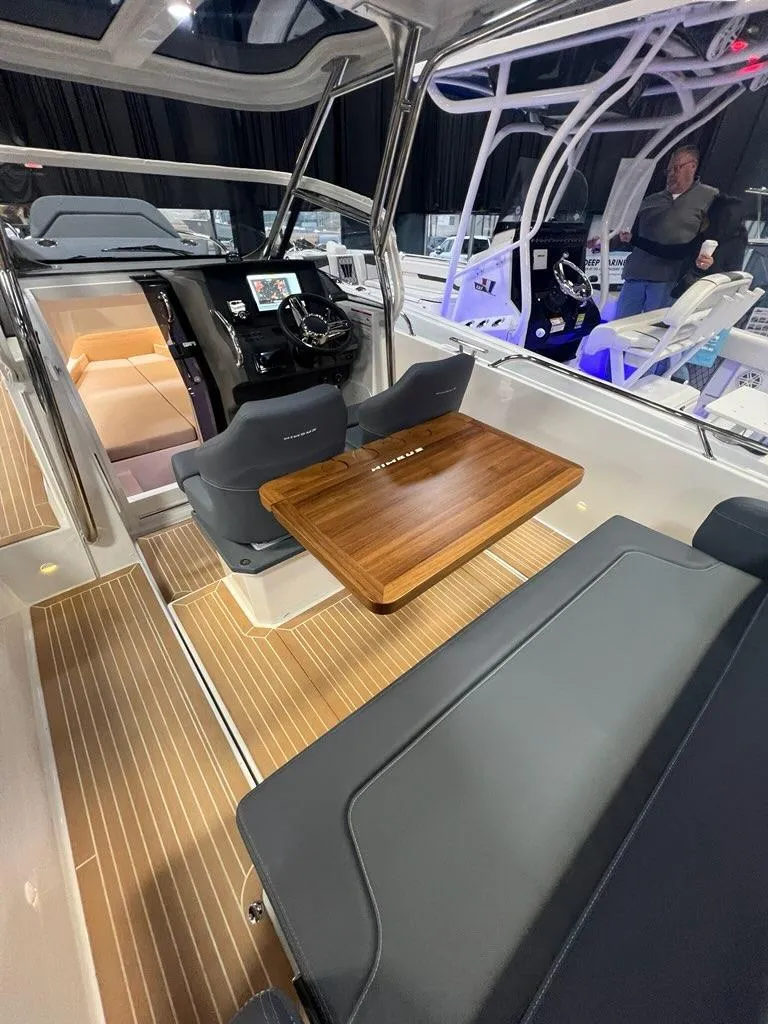 Slide: The Image of 2025 Nimbus Tender 8 interior with sleek seating and wooden table. - 6