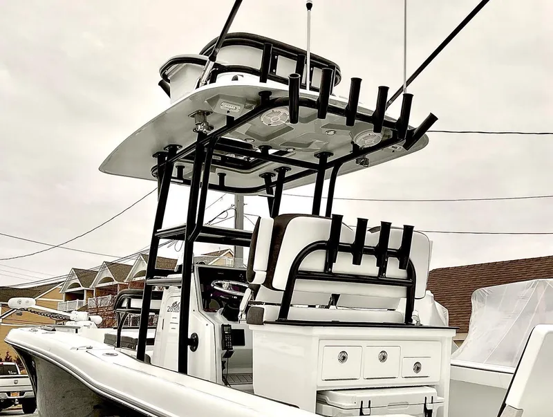 Slide: The Image of 2023 Crevalle 26 HBW boat with T-top and rod holders. - 2