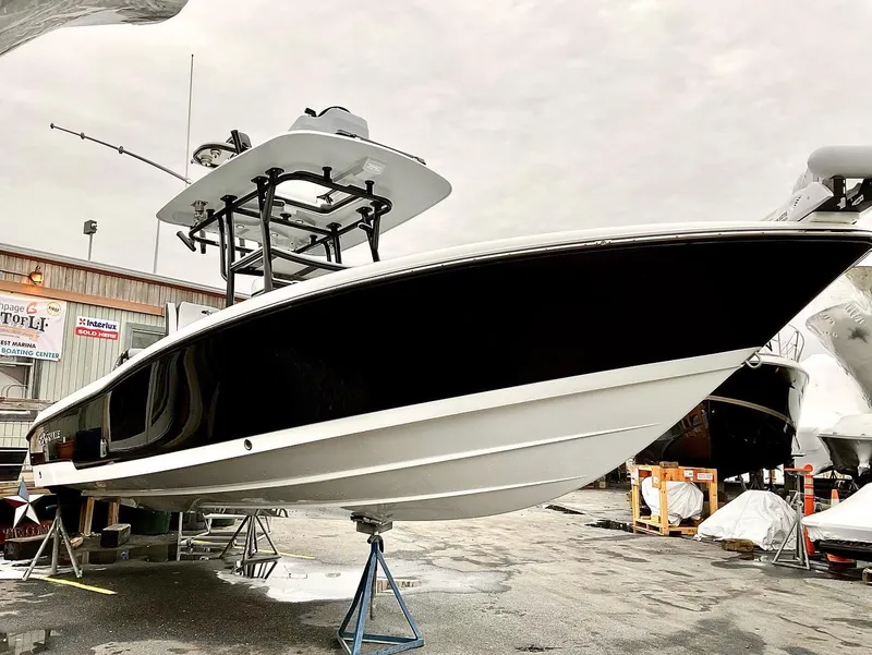 Slide: The Image of 2023 Crevalle 26 HBW boat on display in a marina. - 3