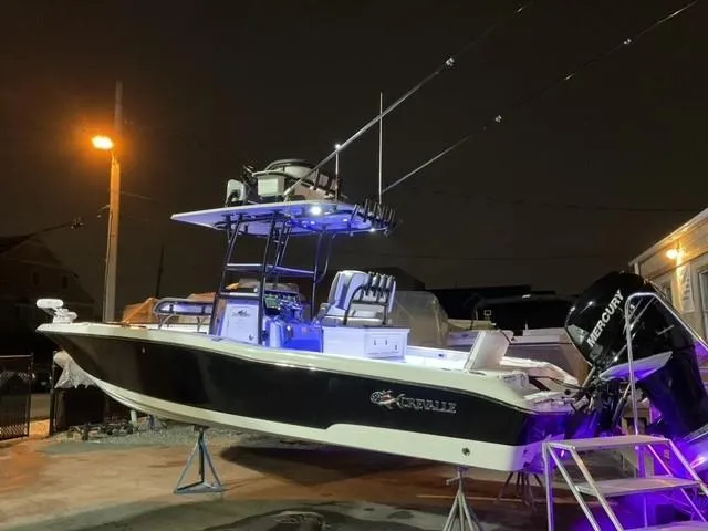 Slide: The Image of 2023 Crevalle 26 HBW boat with Mercury engine, illuminated at night. - 6