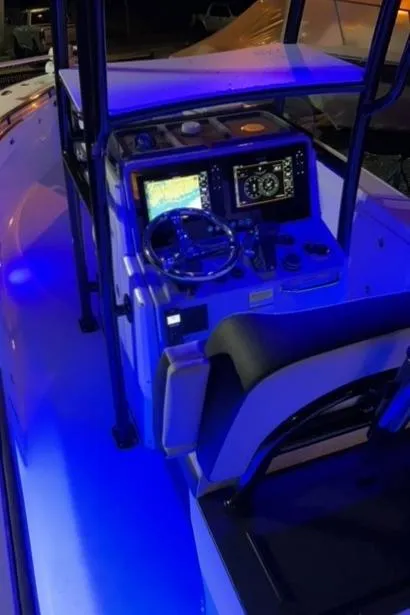 Slide: The Image of 2023 Crevalle 26 HBW boat console with illuminated blue lighting. - 8