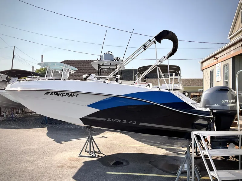 Slide: The Image of 2023 Starcraft 171 SVX boat with Yamaha engine, parked outdoors on a sunny day. - 1