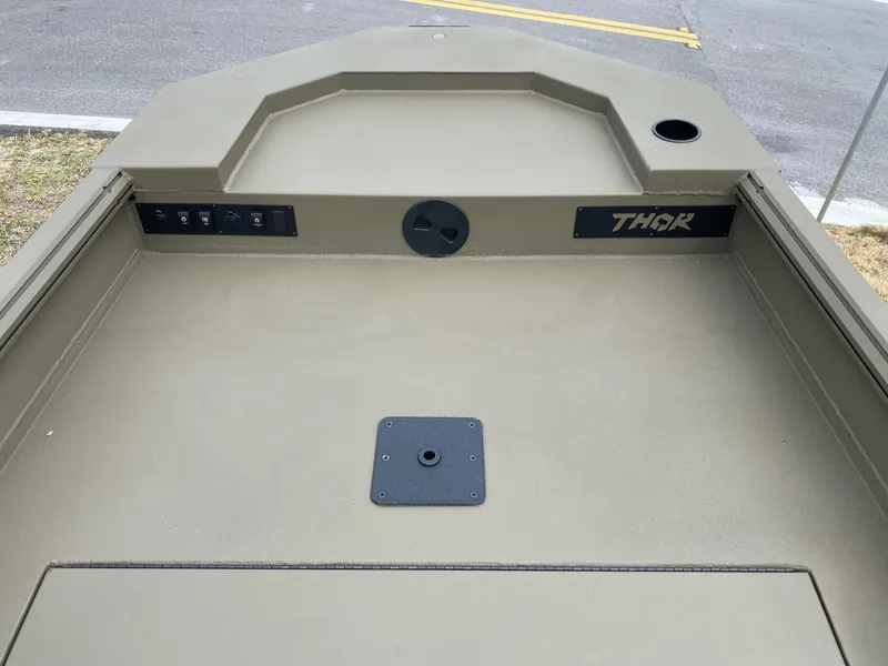 Slide: The Image of 2023 Thor Lake Hammer boat interior, showing control panel and storage area. - 13