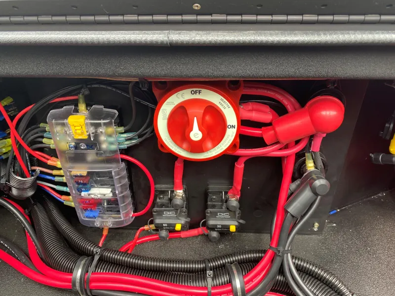 Slide: The Image of Electrical panel with red cables and switches in a 2023 Thor Lake Hammer. - 15