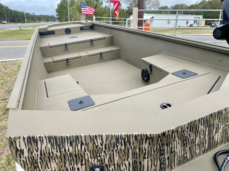 Slide: The Image of 2023 Thor Lake Hammer boat interior with storage compartments and seating. - 4