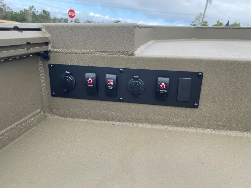 Slide: The Image of Control panel of a 2023 Thor Lake Hammer boat with various switches and outlets. - 6