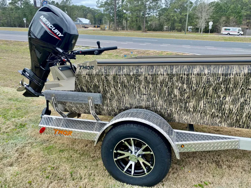 Slide: The Image of 2023 Thor Lake Hammer boat with Mercury outboard motor on a trailer. - 7