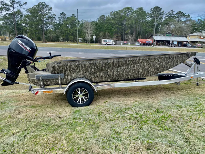 Slide: The Image of 2023 Thor Lake Hammer boat on trailer with Mercury outboard motor. - 8