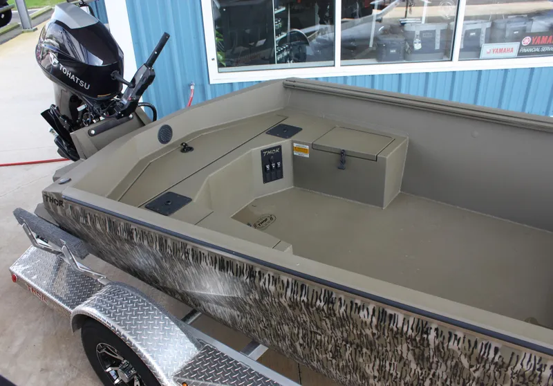 Slide: The Image of 2023 Thor Lake Hammer boat with Tohatsu motor and camo design on trailer. - 4