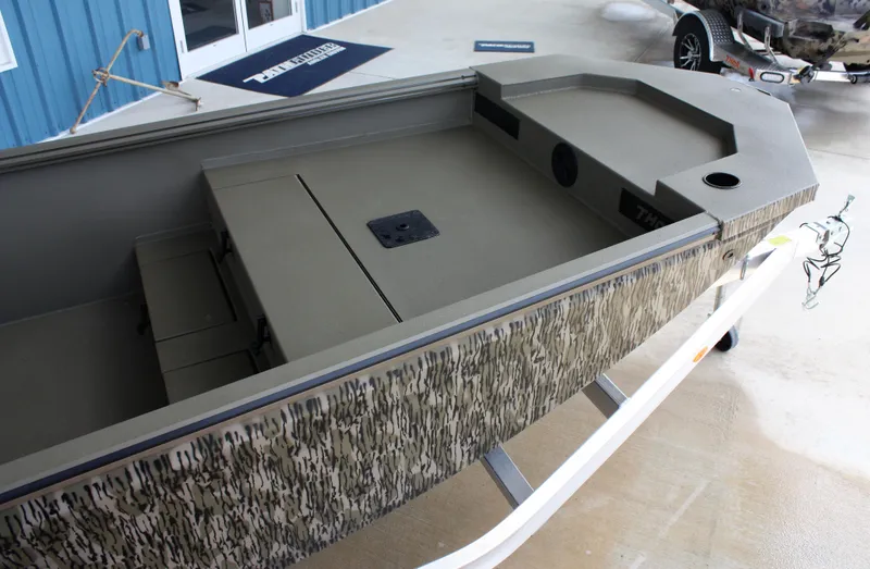 Slide: The Image of 2023 Thor Lake Hammer boat interior with camouflage exterior, docked at a marina. - 5