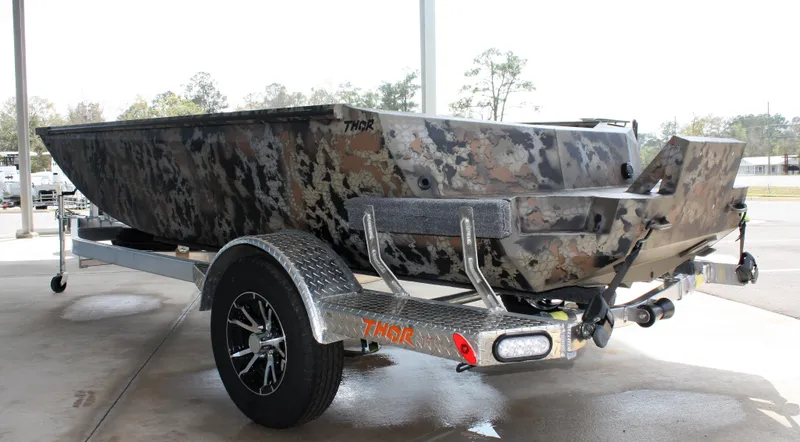 Slide: The Image of 2023 Thor Lake Hammer boat on a trailer with camouflage design. - 11
