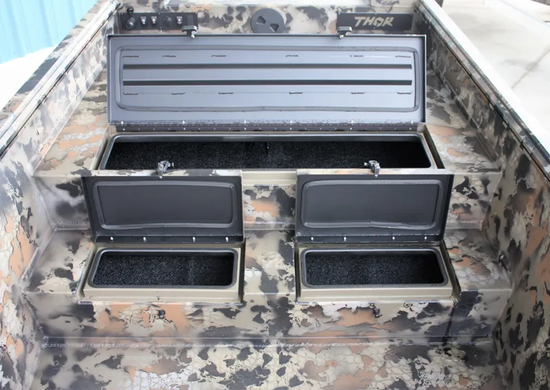Slide: The Image of 2023 Thor Lake Hammer boat with open storage compartments and camouflage design. - 2