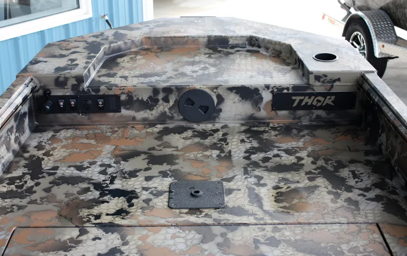 Slide: The Image of 2023 Thor Lake Hammer boat with camouflage pattern and control panel. - 3