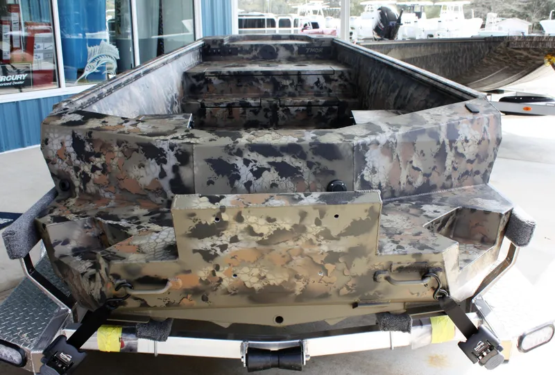 Slide: The Image of 2023 Thor Lake Hammer boat with camouflage design on a trailer. - 8