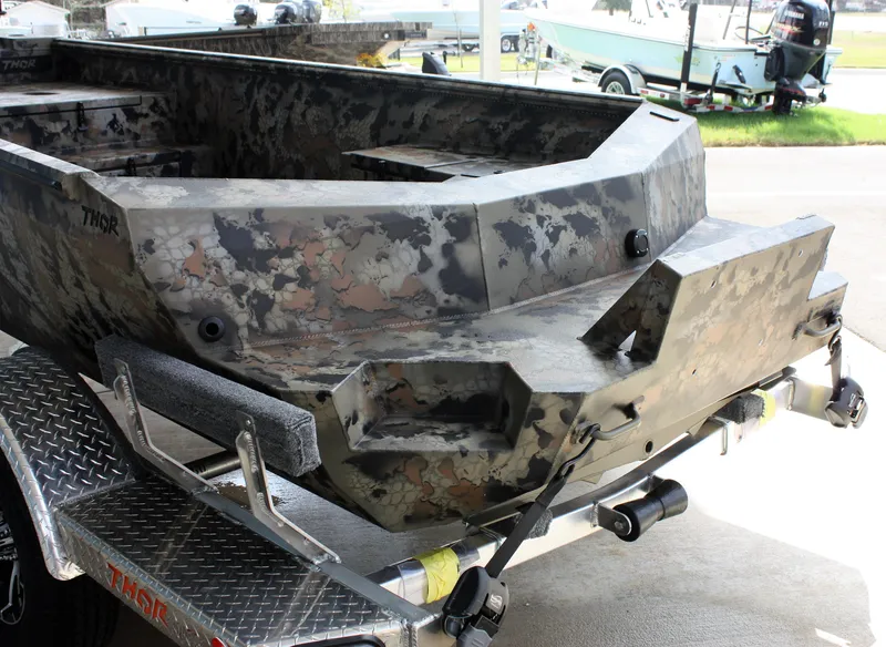 Slide: The Image of 2023 Thor Lake Hammer boat with camouflage design on a trailer. - 9
