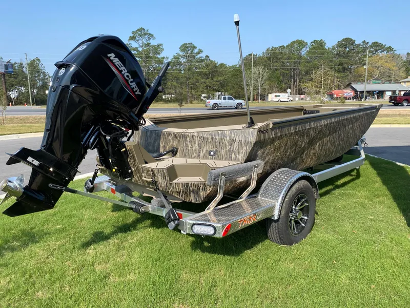 Slide: The Image of 2023 Thor Lake Hammer boat with Mercury outboard motor on a trailer. - 2