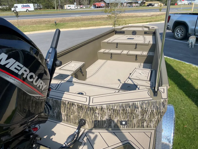 Slide: The Image of 2023 Thor Lake Hammer boat with Mercury outboard motor, parked on a trailer. - 5