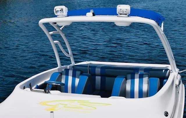 Slide: The Image of 2007 Glasstream 273 XS boat with blue-striped seating on a calm water background. - 13