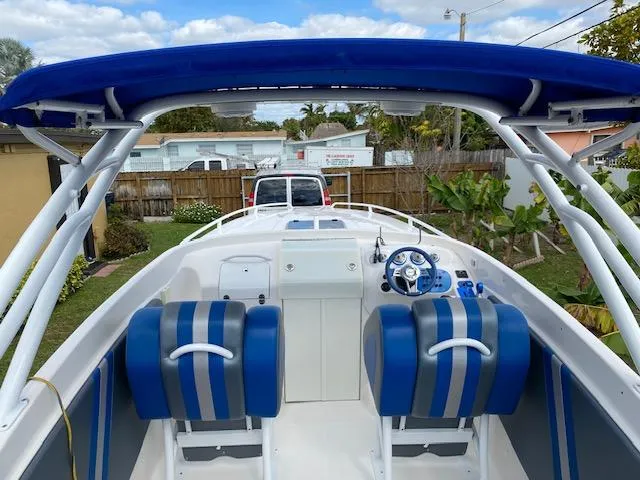 Slide: The Image of 2007 Glasstream 273 XS boat with blue seating and canopy, parked outdoors. - 15