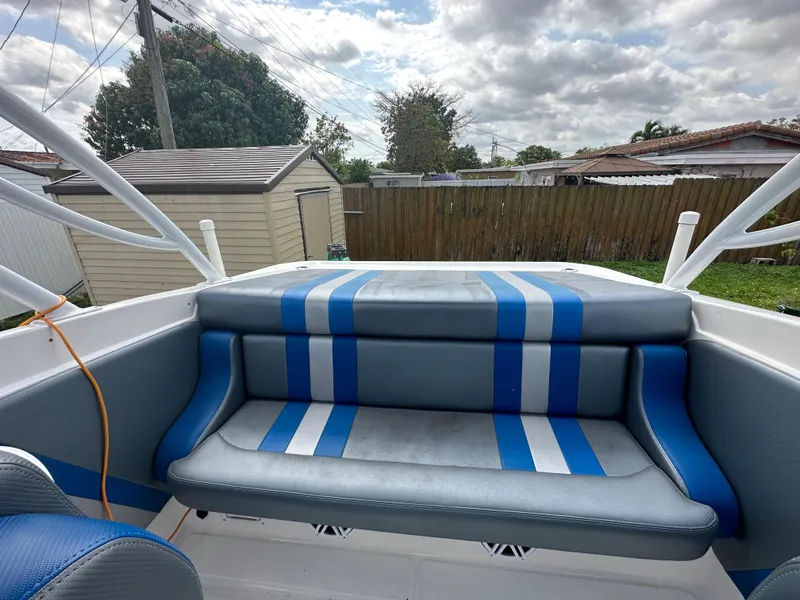 Slide: The Image of 2007 Glasstream 273 XS boat interior with blue and gray seating, outdoor setting. - 17