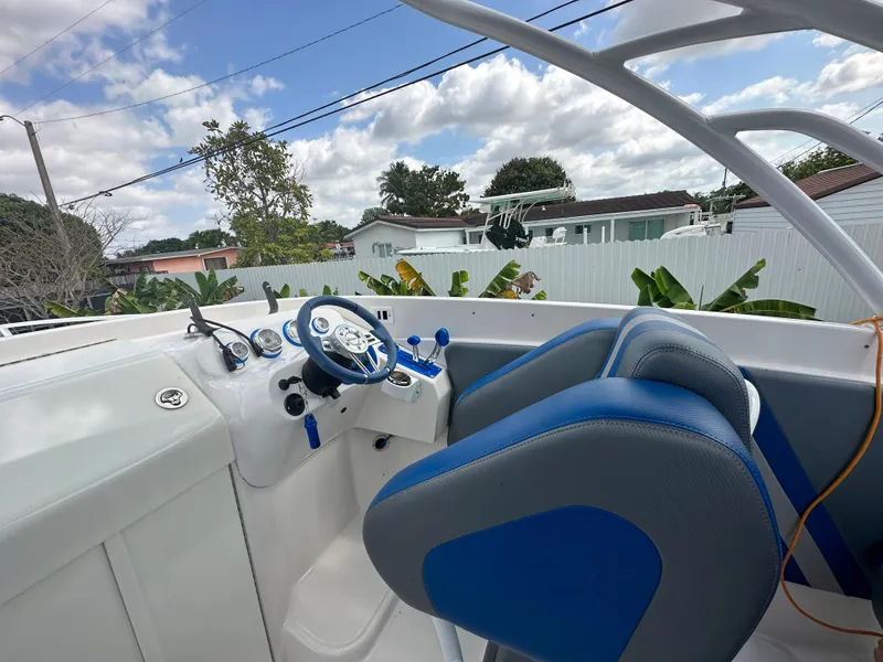 Slide: The Image of 2007 Glasstream 273 XS boat interior with blue and gray seating, steering wheel, and dashboard. - 19