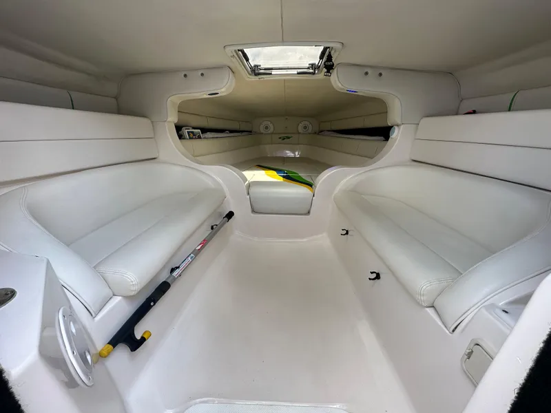 Slide: The Image of Interior of 2007 Glasstream 273 XS boat, featuring white seating and a hatch. - 27