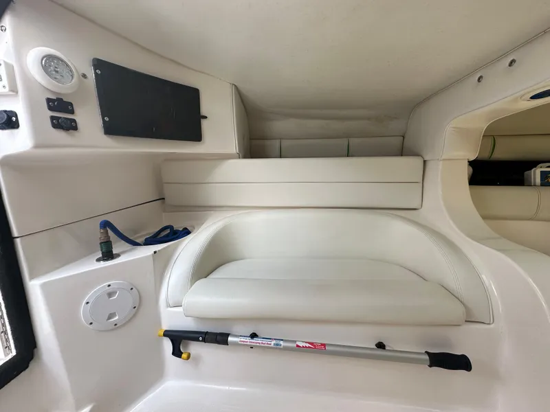 Slide: The Image of 2007 Glasstream 273 XS boat interior with white seating and storage compartments. - 28