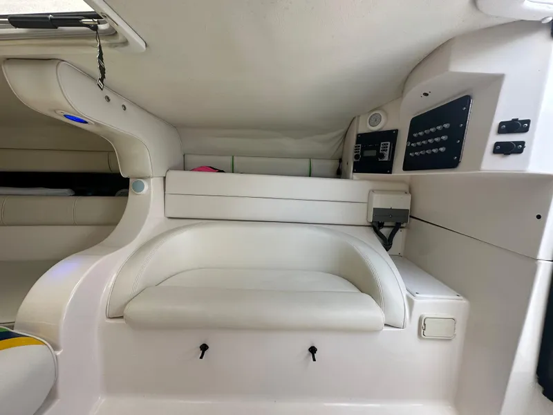 Slide: The Image of Interior cabin of 2007 Glasstream 273 XS boat, featuring white seating and control panel. - 29