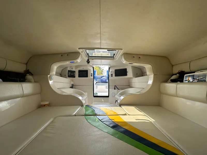 Slide: The Image of Interior of 2007 Glasstream 273 XS boat with white seating and colorful floor design. - 33