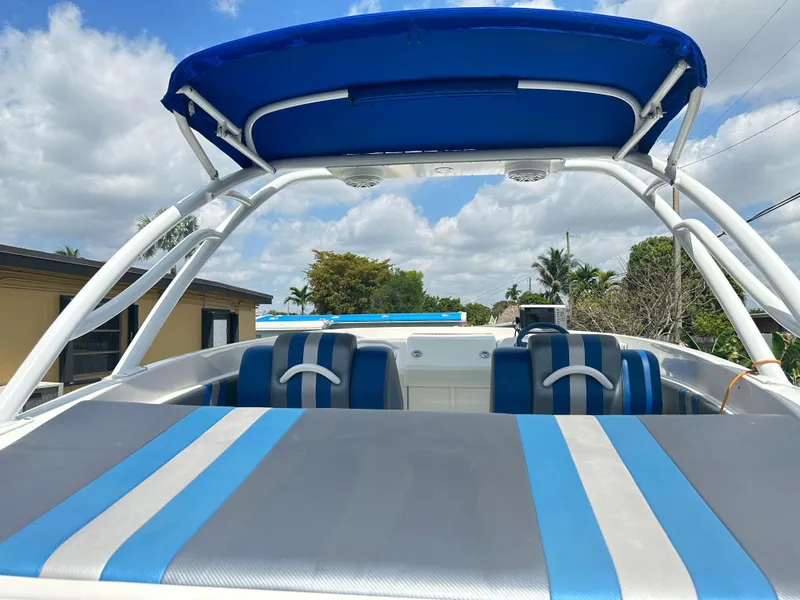 Slide: The Image of 2007 Glasstream 273 XS boat with blue and gray seating, under a blue canopy. - 7