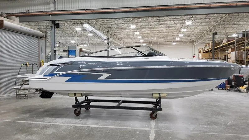 The Image of 2023 Formula 240 Bowrider in storage, covered, with other boats in a warehouse. - 0