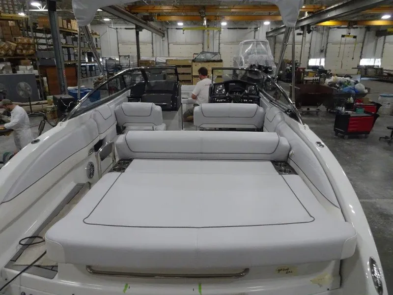 Slide: The Image of 2023 Formula 240 Bowrider boat in a warehouse setting, showcasing sleek design and modern features. - 13