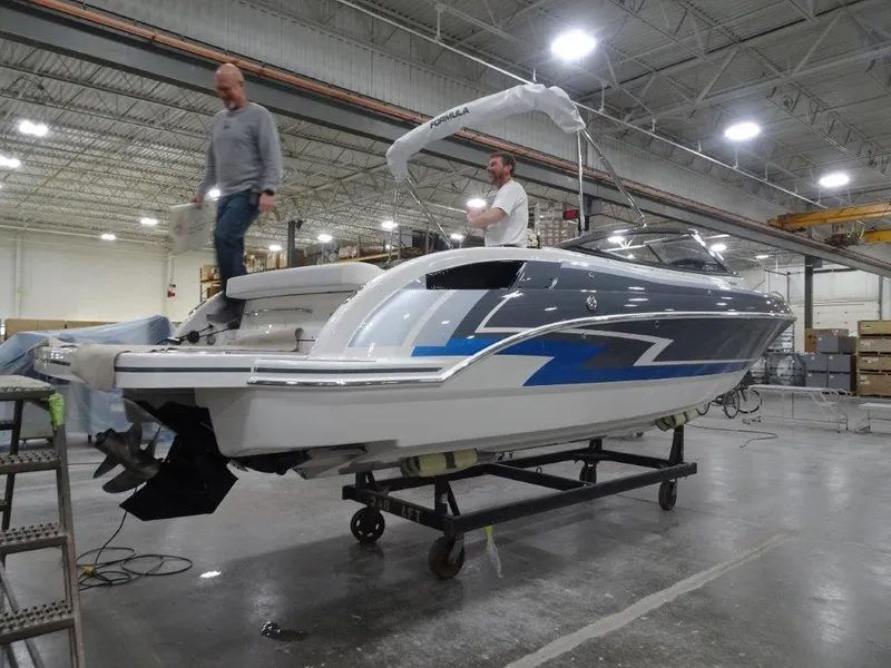 Slide: The Image of 2023 Formula 240 Bowrider boat in indoor storage facility, front view. - 2