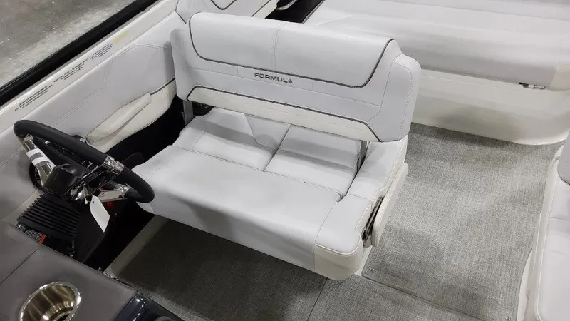 Slide: The Image of 2023 Formula 240 Bowrider interior with white seating and steering wheel. - 23