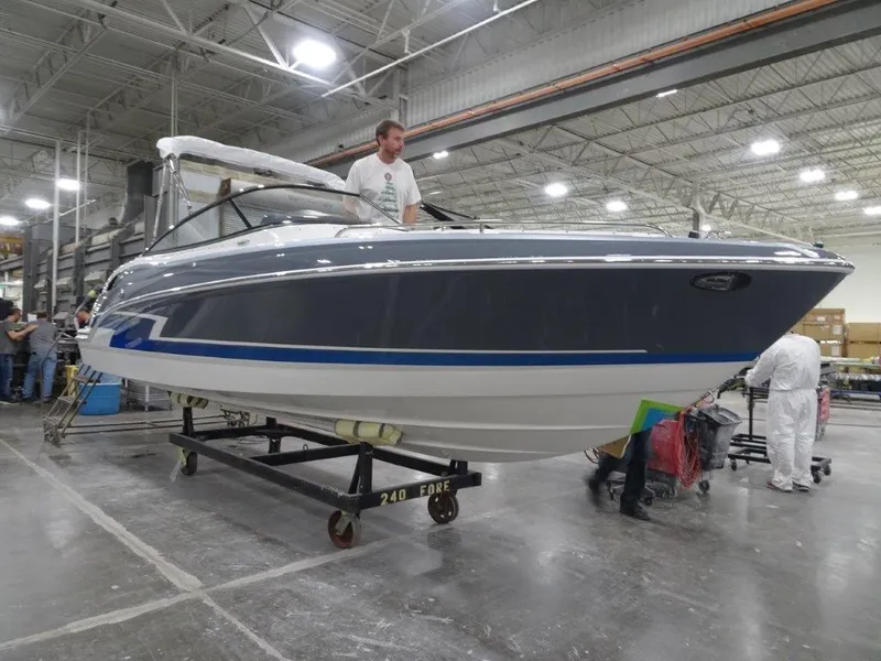 Slide: The Image of 2023 Formula 240 Bowrider interior with steering wheel and seating in a warehouse setting. - 3