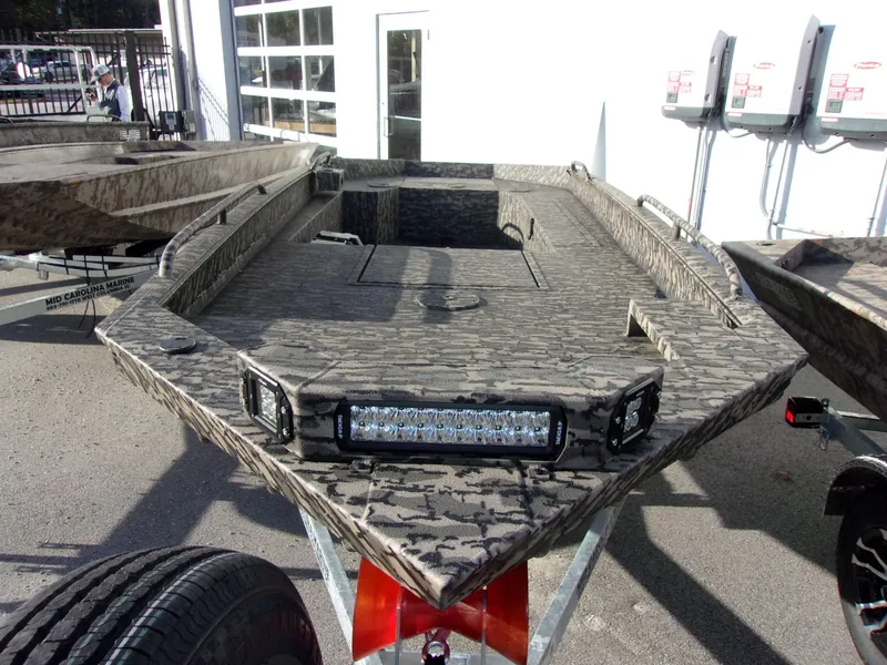 Slide: The Image of 2023 Legendcraft Boats Ambush Elite 1652 MD with camouflage design and LED lights. - 5