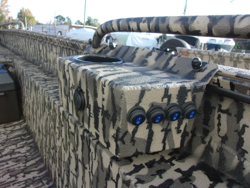 Slide: The Image of Camouflage interior of 2023 Legendcraft Boats Ambush Elite 1652 MD with control switches. - 8