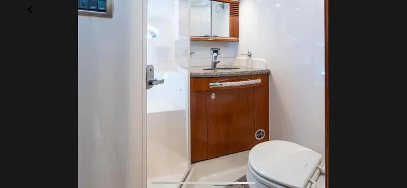 Slide: The Image of 2005 Sea Ray 500 Sundancer yacht bathroom with wooden cabinetry and modern fixtures. - 12