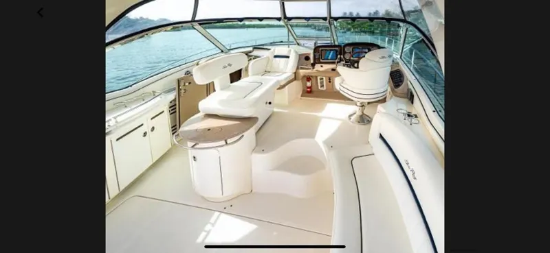 Slide: The Image of Interior of 2005 Sea Ray 500 Sundancer yacht with luxurious seating and navigation area. - 16