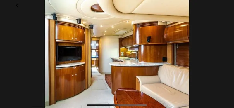Slide: The Image of Luxurious interior of a 2005 Sea Ray 500 Sundancer yacht with wooden cabinetry and leather seating. - 4