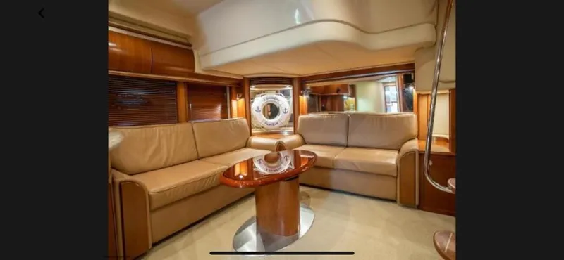 Slide: The Image of Luxurious interior of 2005 Sea Ray 500 Sundancer yacht with leather seating and wooden table. - 5