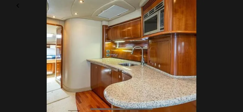Slide: The Image of Luxurious kitchen area in a 2005 Sea Ray 500 Sundancer yacht with granite countertops. - 7