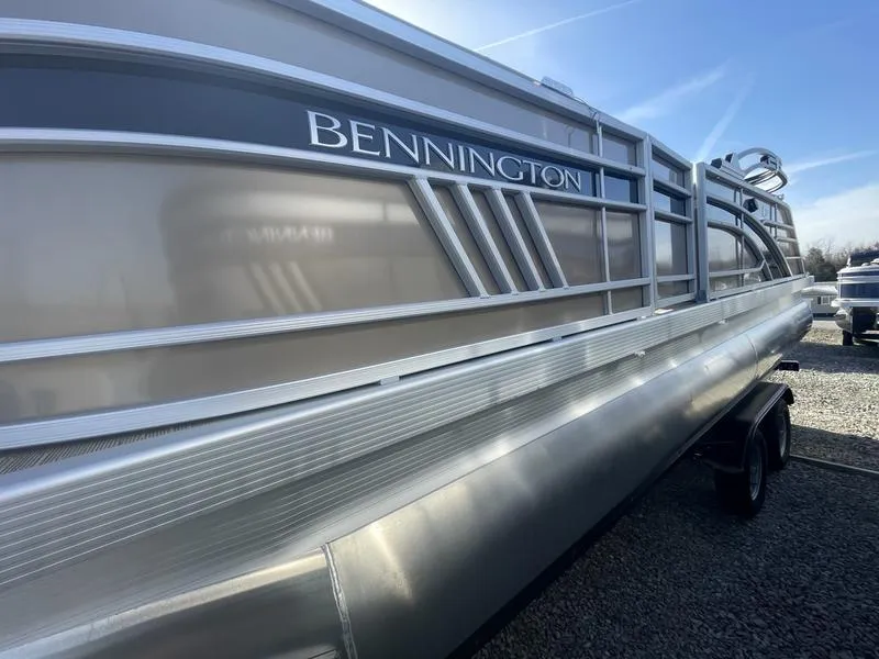 Slide: The Image of 2023 Bennington 22 LFB pontoon boat side view in a parking lot. - 1