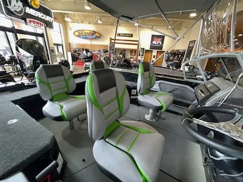 Slide: The Image of 2023 Ranger 620FS Ranger Cup Equipped boat interior with green and gray seats in showroom. - 7