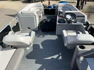 Slide: The Image of 2023 Sweetwater 2286SBX pontoon boat interior with seating and steering console. - 2