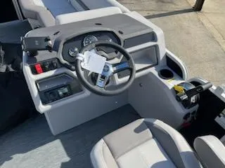 Slide: The Image of 2023 Sweetwater 2286SBX boat cockpit with steering wheel and control panel. - 6