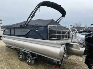 Slide: The Image of 2024 Sweetwater 2286SFL pontoon boat with black canopy and trailer. - 12