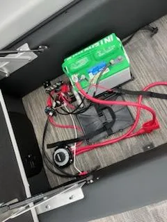 Slide: The Image of Battery compartment of a 2024 Sweetwater 2286SFL boat with wiring and components. - 13